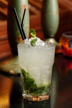 Close-up of a mojito cocktail with fresh mint and crushed ice, perfect for summer enjoyment.